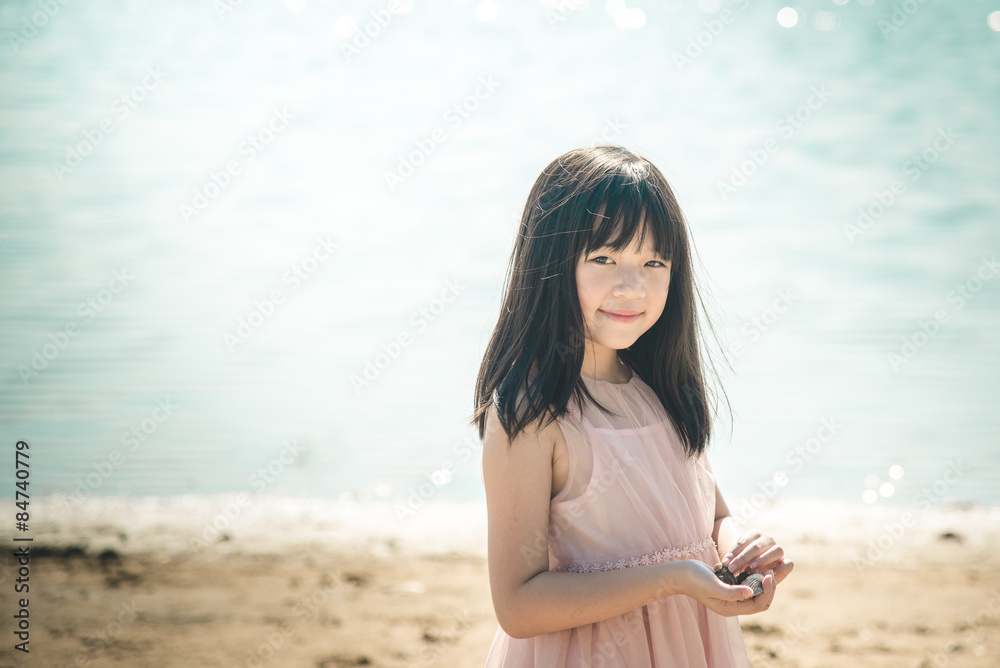 Beautiful asian girl smiling on the beach