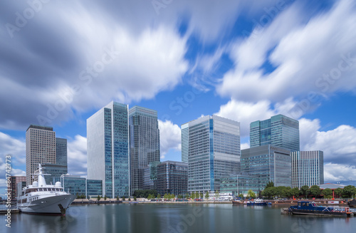 Skyscrapers of Canary Wharf with moving clouds in color, London, UK