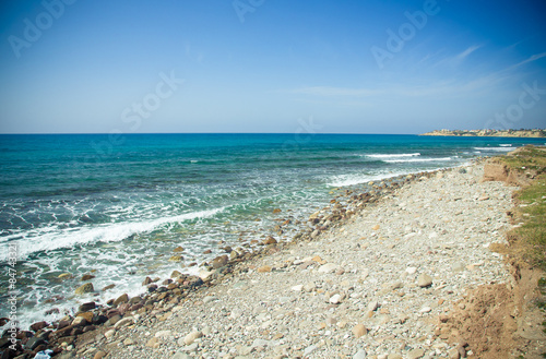 Pebble beach and blue water of the Mediterranean Sea. Toned