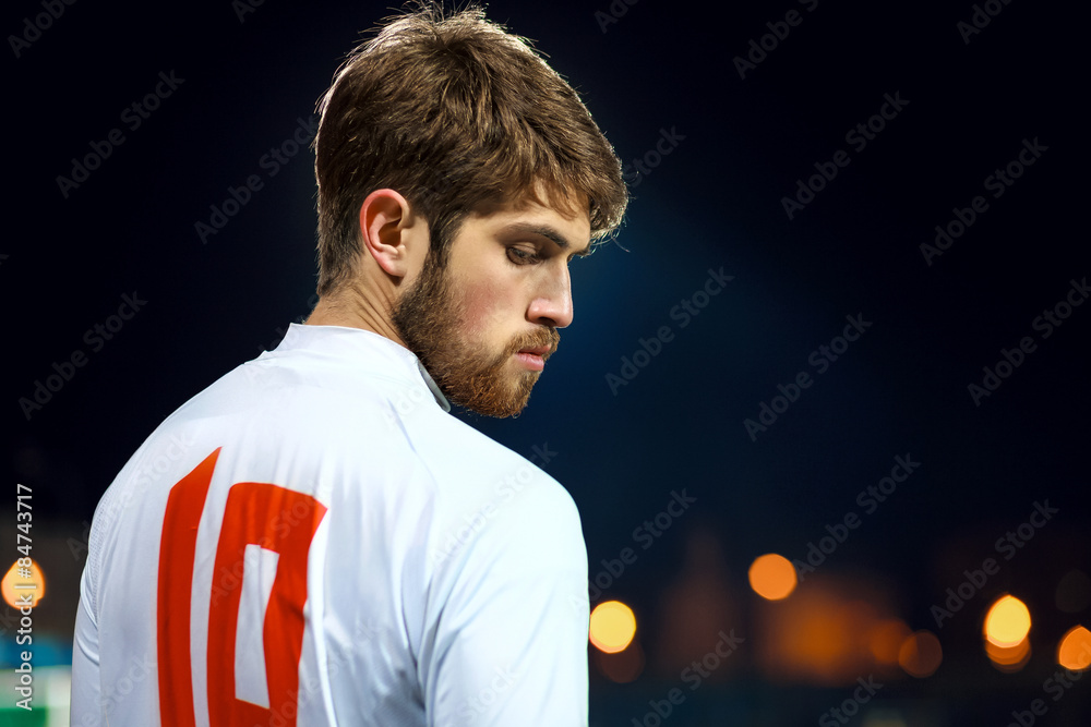 Fototapeta premium Soccer player on the stadium, night time