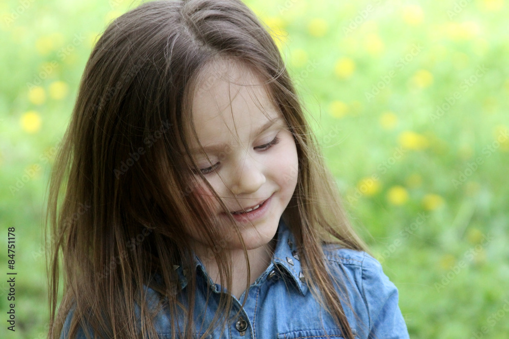 Girl with long hair among dandelion field