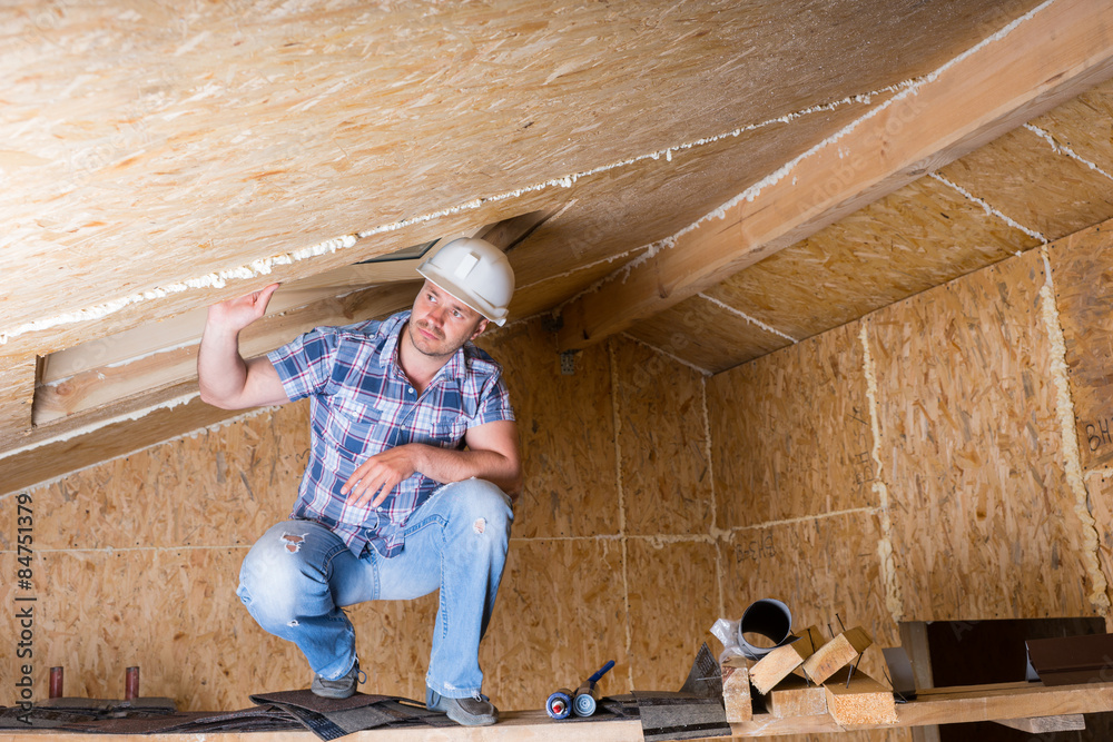 Fototapeta premium Builder on Scaffolding in Unfinished House
