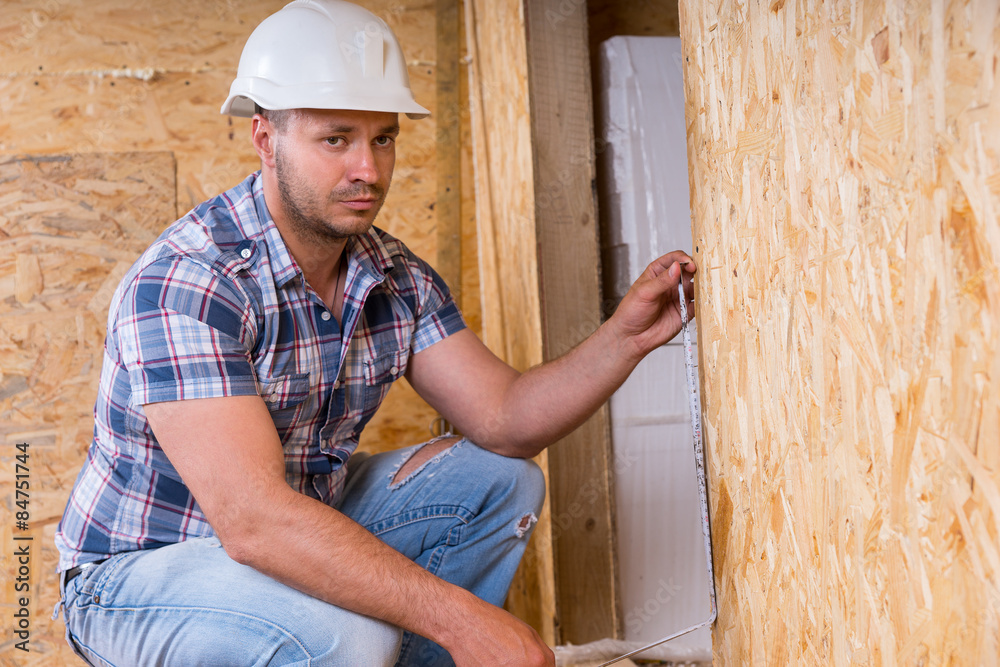 Builder Measuring Door Frame In Unfinished Home Builder Measuring Door Frame In Unfinished Home
