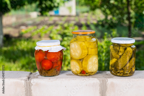 Jars of Preserved Vegetables on Garden Wall