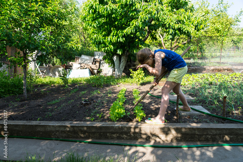 Young girl working in a veggie garden