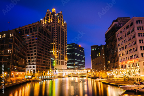Buildings along the Milwaukee River at night, in Milwaukee, Wisc photo