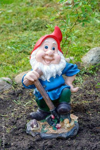 Little funny garden gnome in the garden 