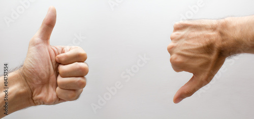 A hand with thumb up and one thumb down