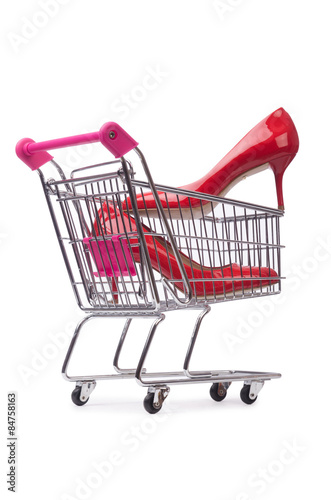 Woman shoes in shopping cart on white © Elnur
