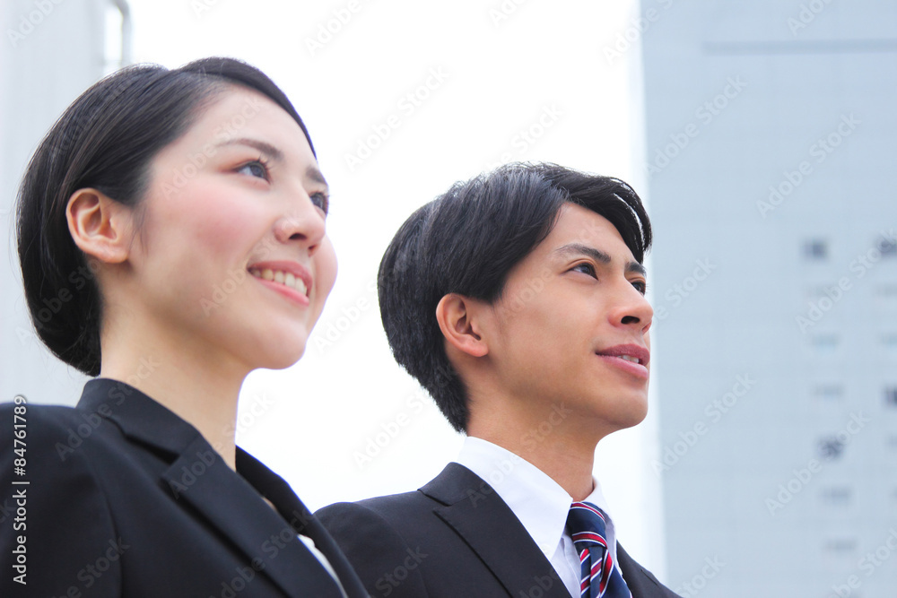 Asian businessman and businesswoman looking up at the sky
Asian businessman and businesswoman looking up at the sky