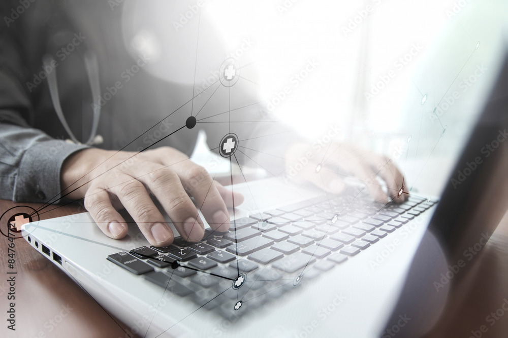Doctor working with digital tablet and laptop computer in medica Doctor working with digital tablet and laptop computer in medica