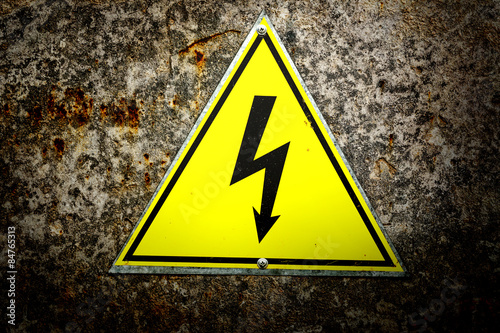 Old yellow high voltage sign