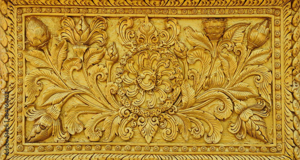 The gold stucco design of native thai style on the Wall