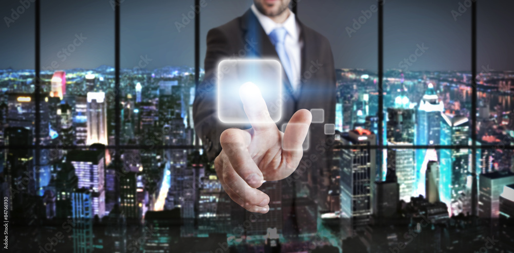Fototapeta premium Businessman in his office using tactile interface