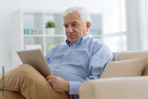 Senior man with digital tablet