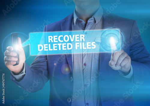 Schilderij op canvas Businessman presses button recover deleted files on virtual scre