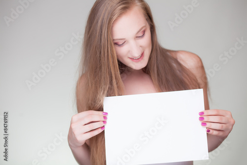 smiling woman holding blank business sign board