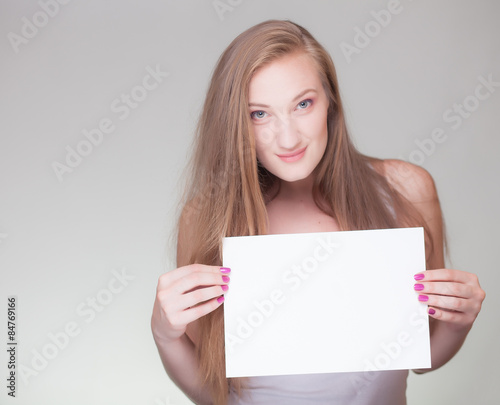 smiling woman holding blank sign board