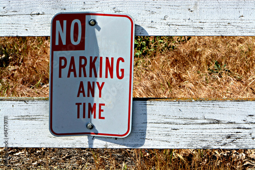 No Parking Street Sign on the Fence
