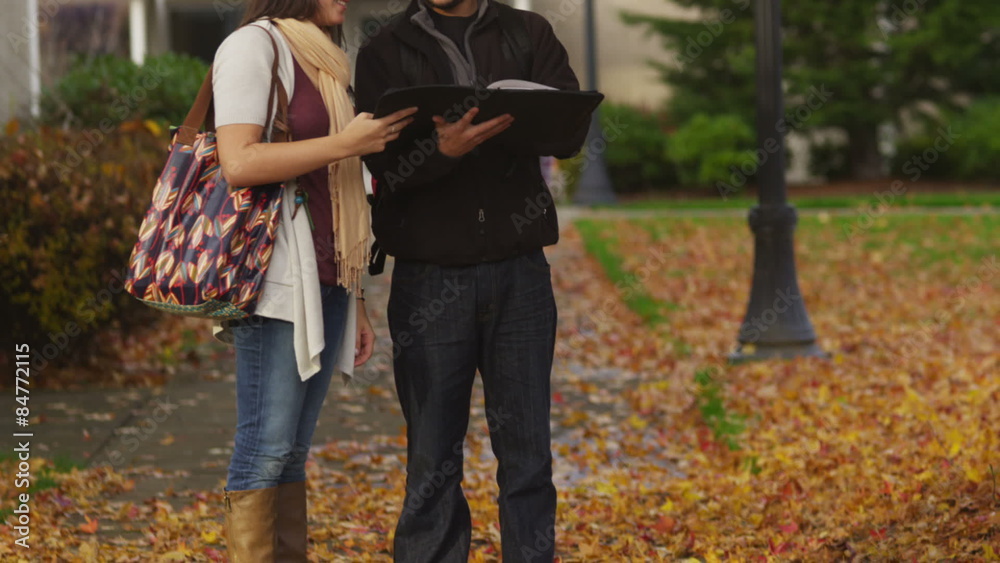 Three college students talking together on campus