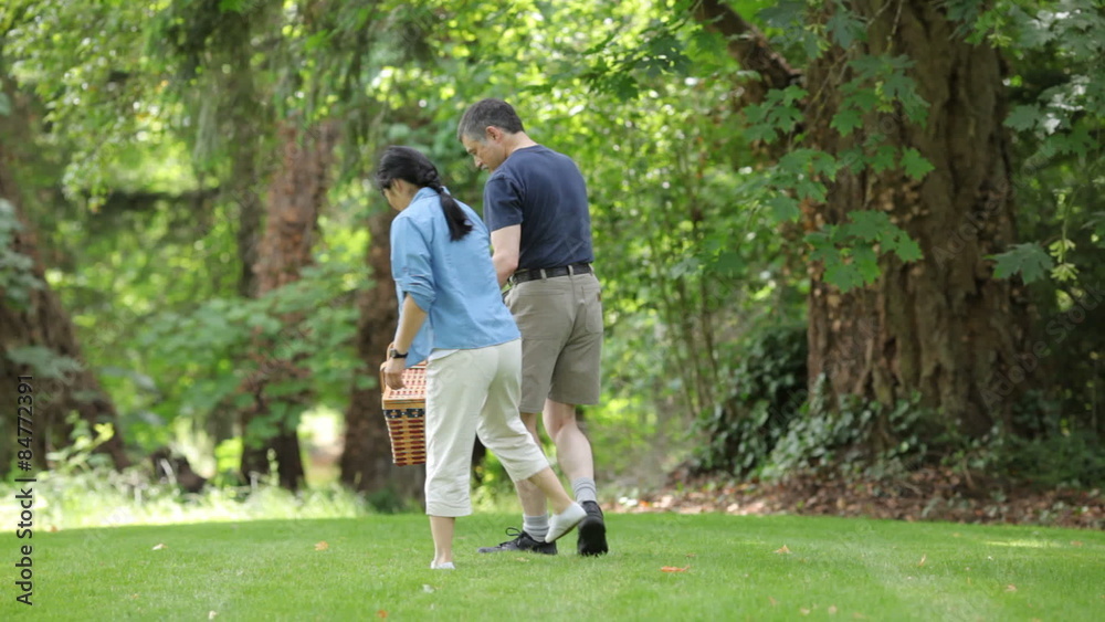 Mature Asian couple preparing for a picnic Mature Asian couple preparing for a picnic