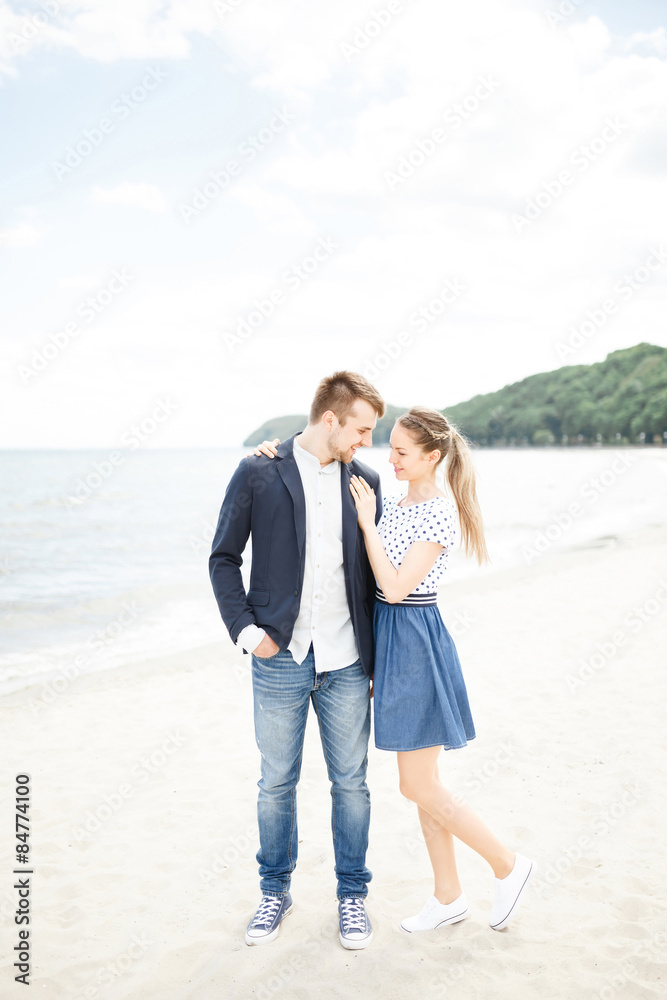 European couple relaxing on the sea beach hugging each other and talking European couple relaxing on the sea beach hugging each other and talking