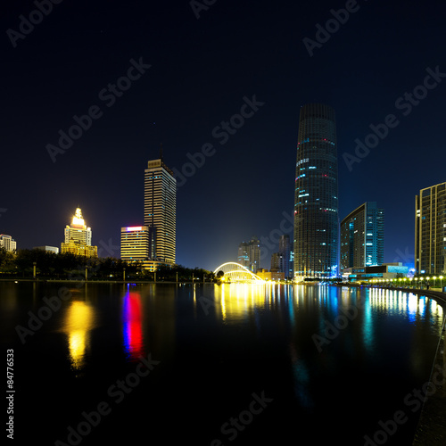 Illumintaed modern skyscrapers and skyline at riverbank