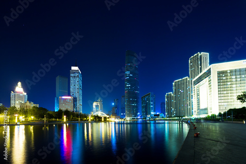 Illumintaed modern skyscrapers and skyline at riverbank