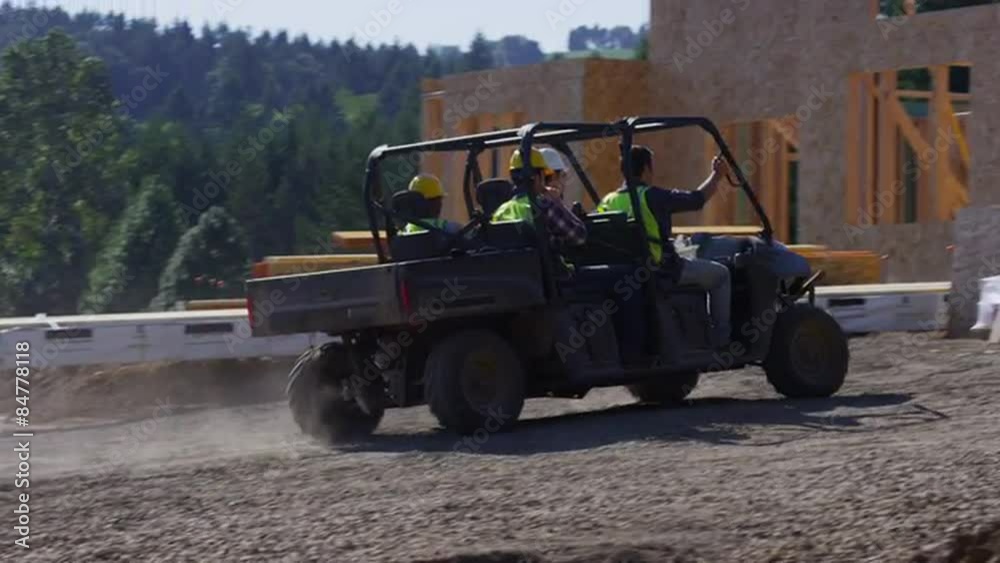 Construction workers driving utility vehicle to job site Construction workers driving utility vehicle to job site