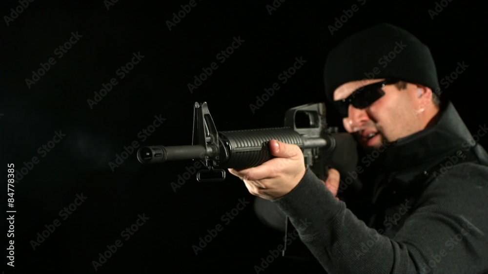 SWAT man shoots assault rifle, slow motion SWAT man shoots assault rifle, slow motion