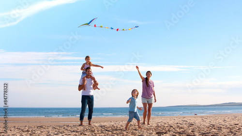 Family on Beach with Kite