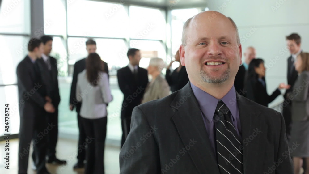 Portrait of businessman with people in background Portrait of businessman with people in background
