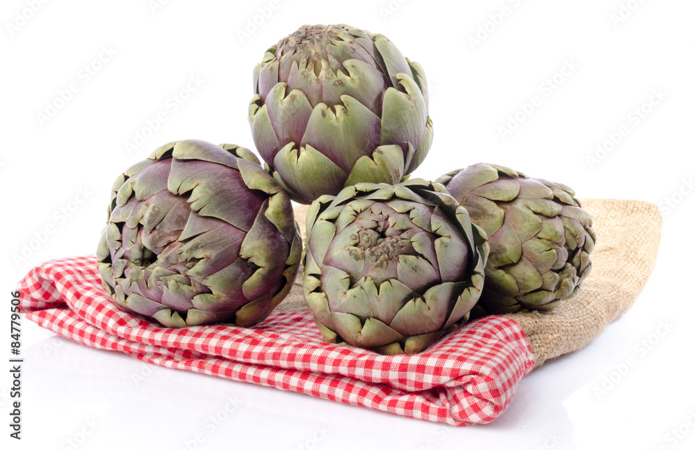 Fototapeta premium Fresh green purple artichokes on burlap