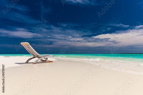 Beach view of amazing water and empty chair on sand for relaxing