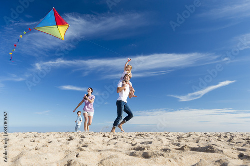 Family on the Beach Flying a Kite