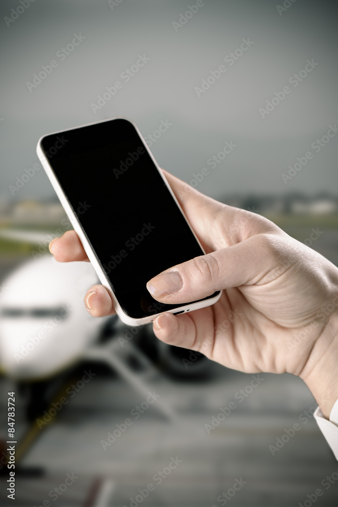 hand using Smartphone in the airport