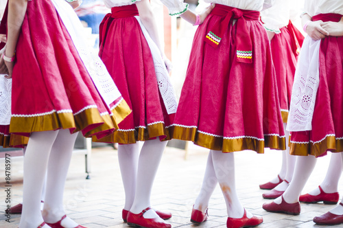 Girls in Slavonic national costumes preparing for a dance performance.