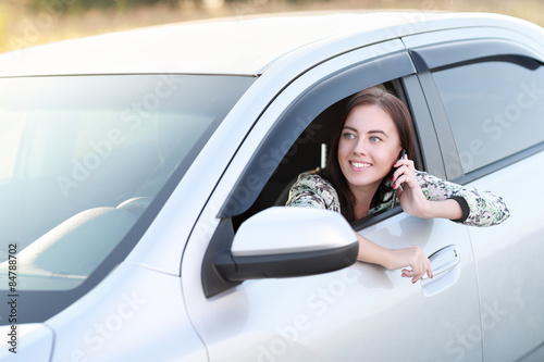 Young woman driving  car © JENOCHE