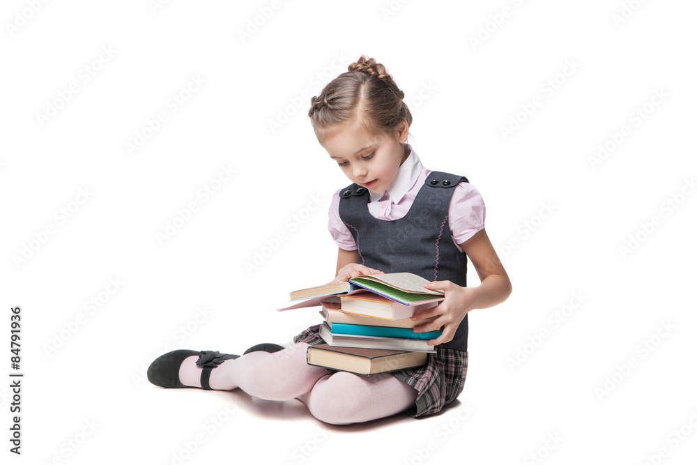 Beautiful little girl in school uniform with books sitting on Beautiful little girl in school uniform with books sitting on