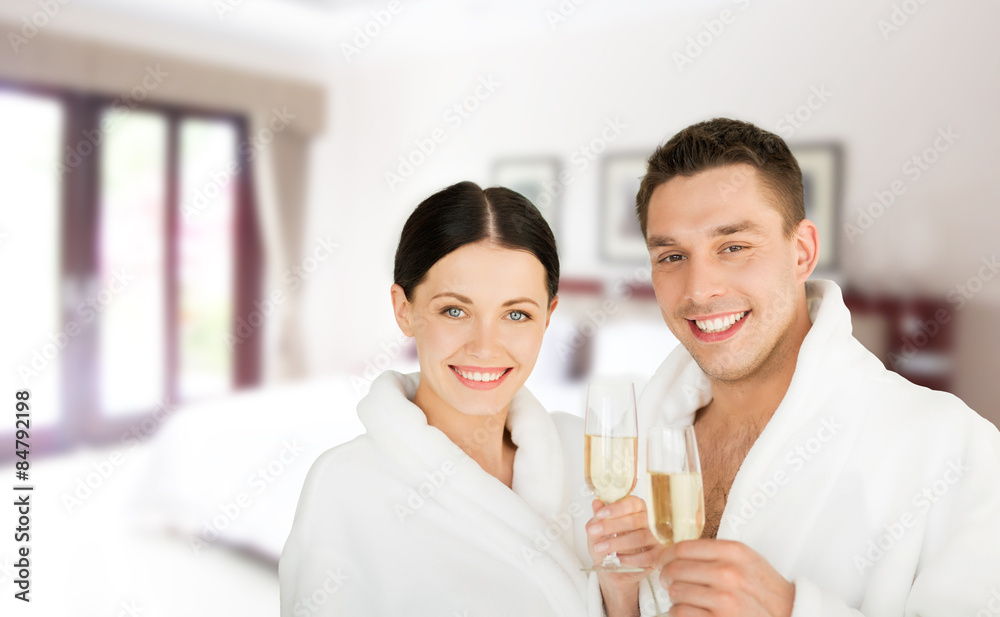 happy couple in bathrobes over spa hotel room happy couple in bathrobes over spa hotel room