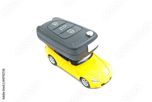 yellow car and car keys on white