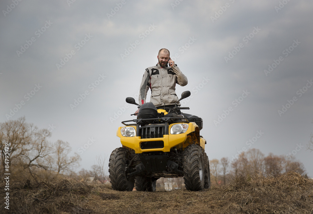 Fototapeta premium ATV driver talking on the phone while driving