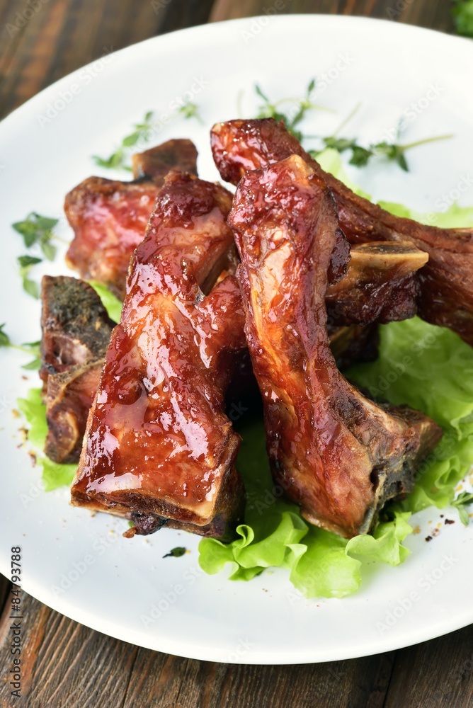 Grilled pork ribs on white plate