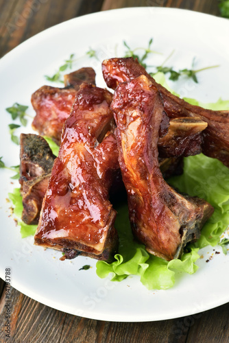 Grilled pork ribs on white plate