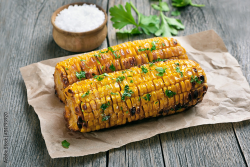 Grilled corn cobs on rustic table