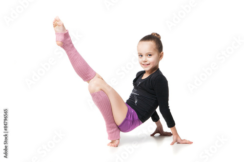 pretty little girl doing gymnastics over white background