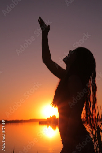 Girl at the lake at sunset