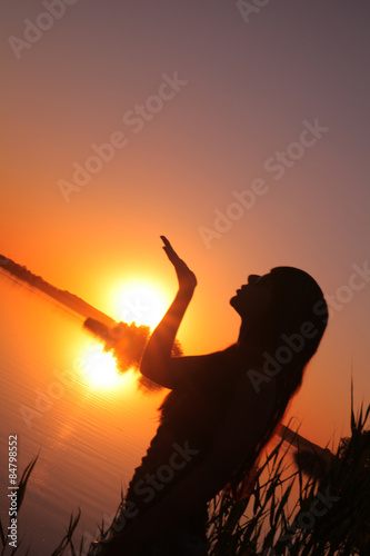 Girl at the lake at sunset