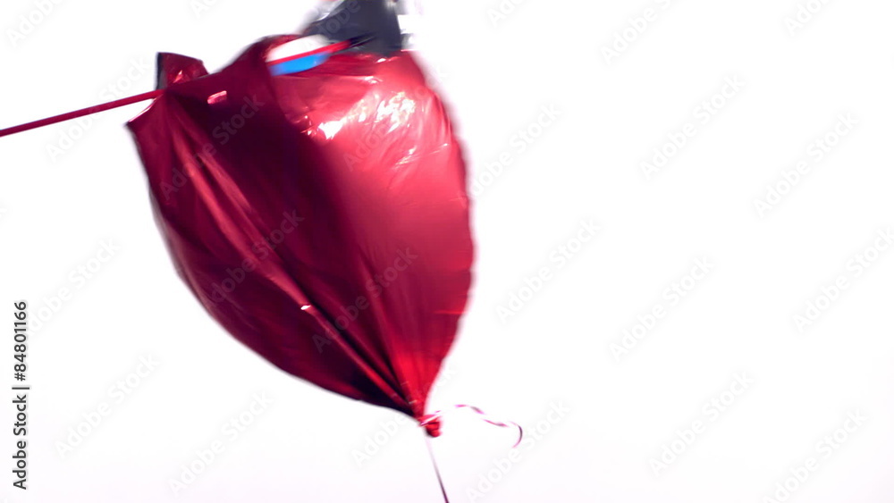 Arrow shot through a heart shaped Valentine's Day balloon