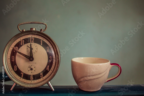 Watch and cup on vintage background